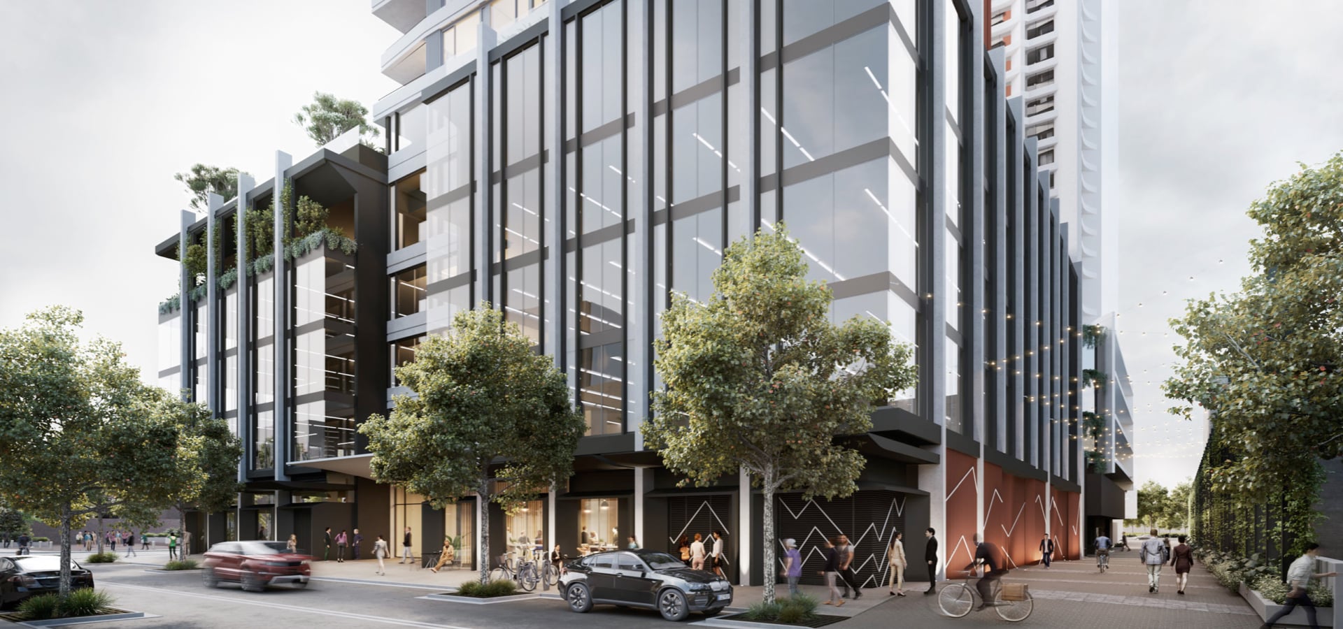 A residential building with trees and people on the street.