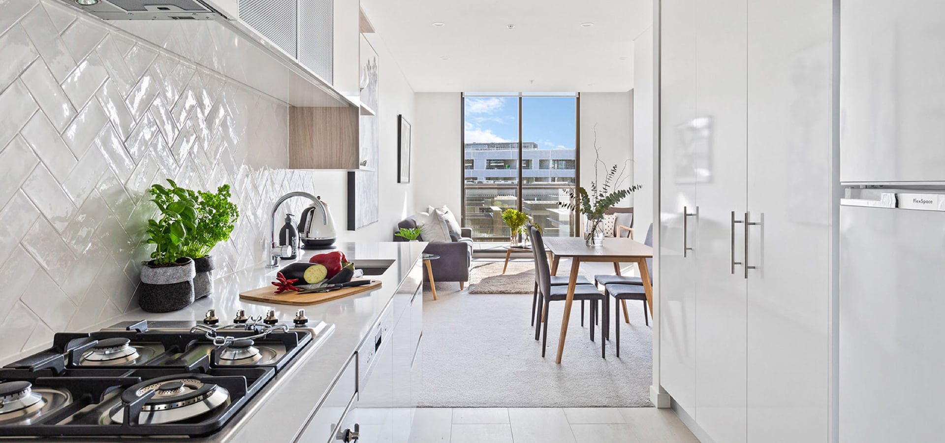 A kitchen with a table and chairs.