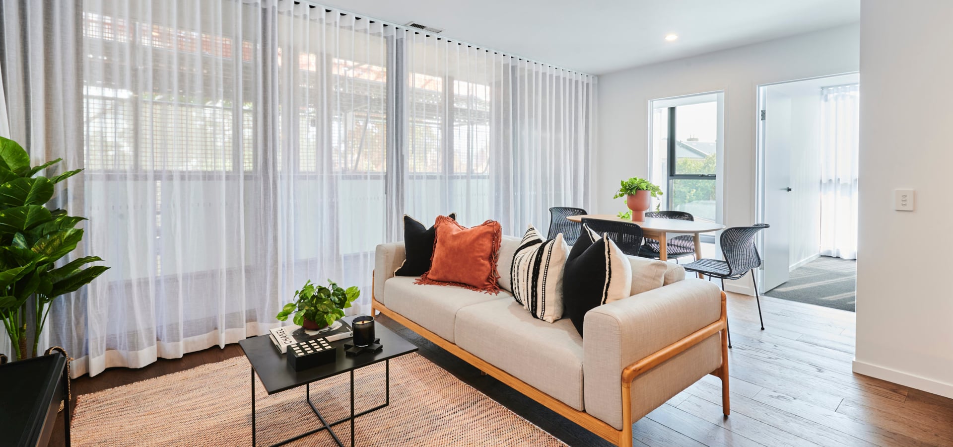 A living room with a couch and a table.
