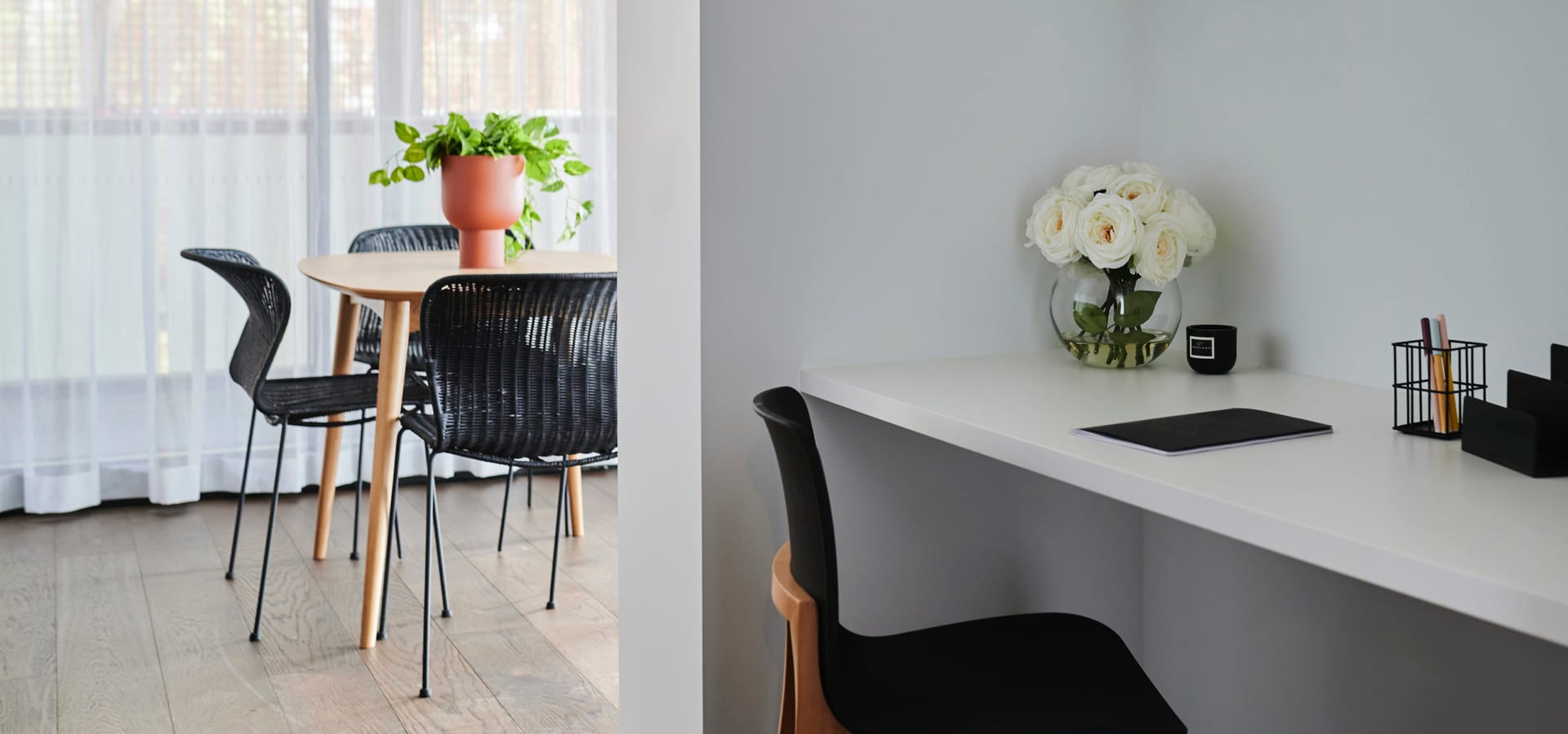 An office nook with a kitchen table with chairs and vase behind it.